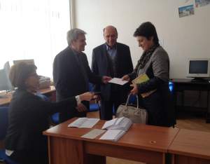 Dr. Haroutiun Arzoumanian giving the stipend to Knarig Avedisian of Garpi School